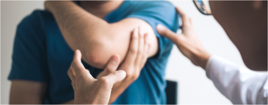 Doctor examines an injured arm