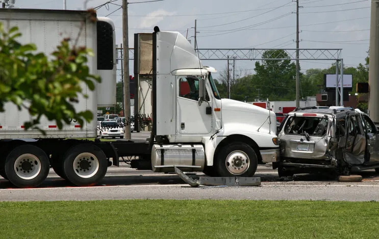 a white commercial truck crashed into a grey mini van