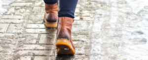 person working in boots on an icey pathway slip and falls in Northern Virginia