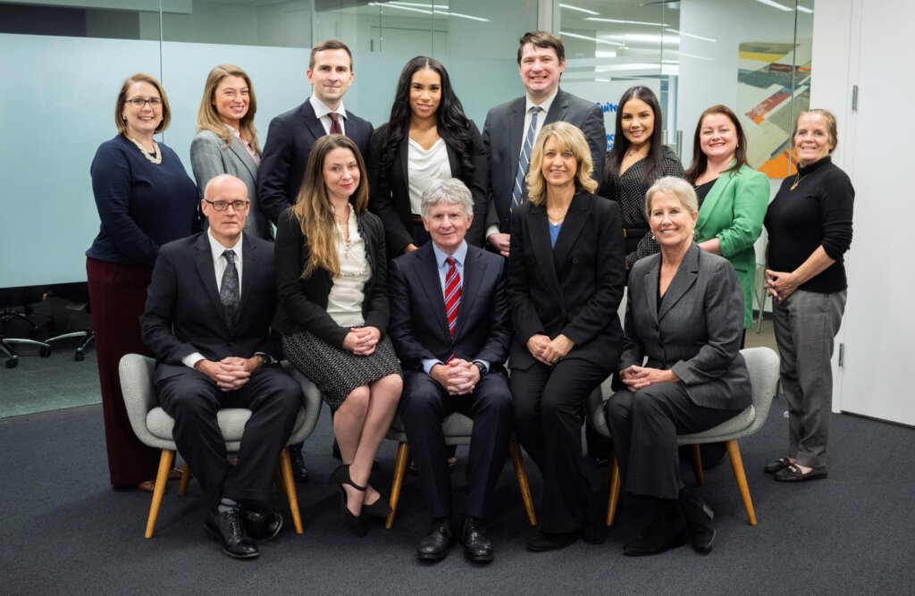 Koonz office sitting together for a company group photo