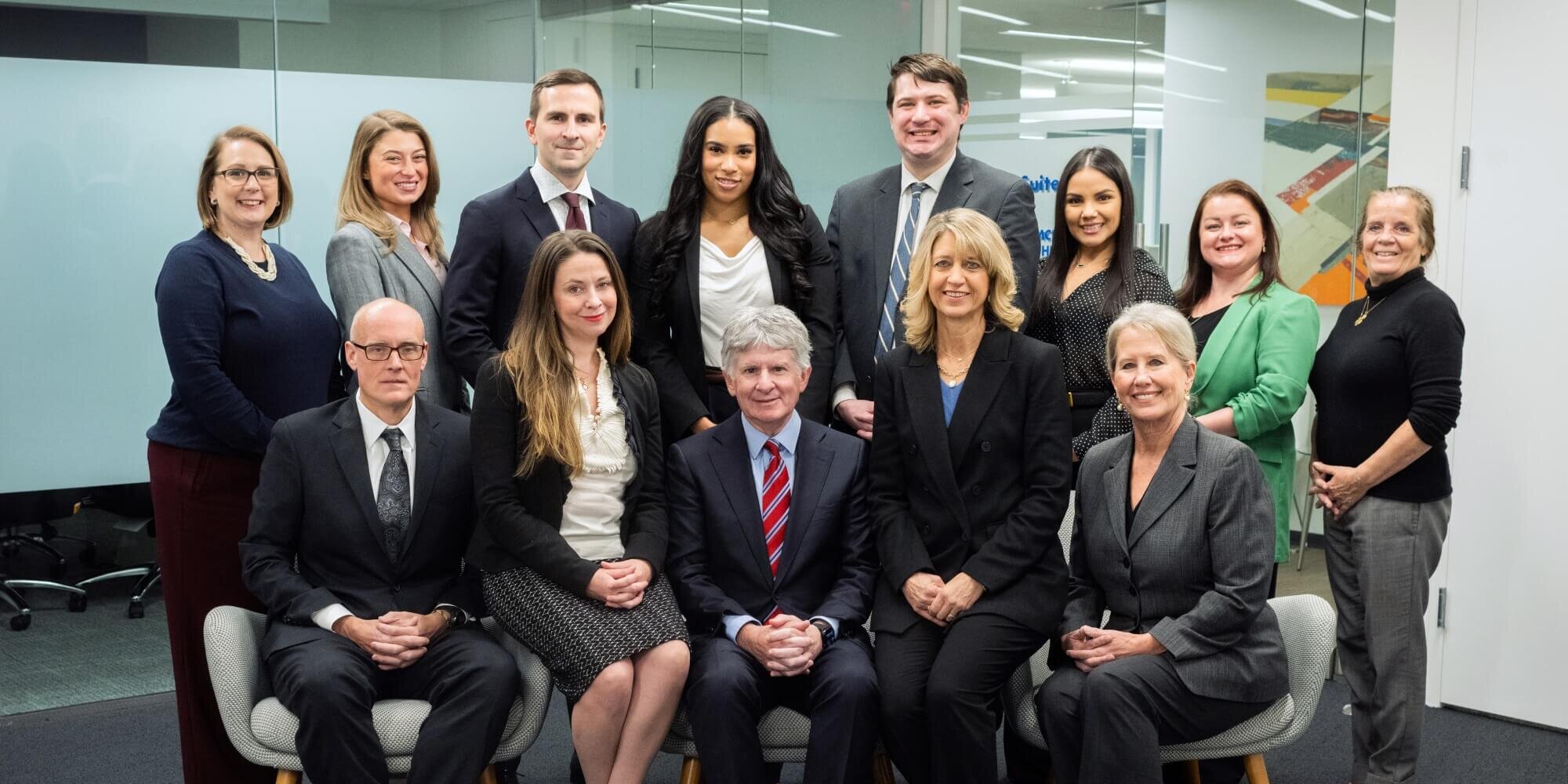 Koonz office sitting together for a company group photo