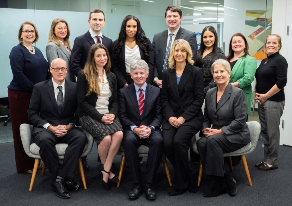 Koonz office sitting together for a company group photo