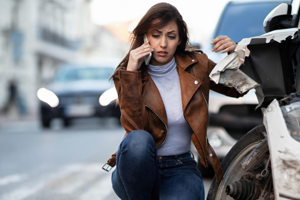 woman making a phone call following a car accident