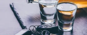 2 shot glasses and car keys on a counter dui accident driving in Suburban Maryland