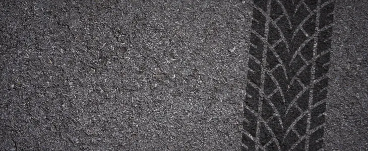 Road with black tire marks present
