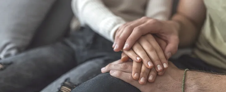 couple with hands intertwined and sad because of wrongful death in Suburban Maryland