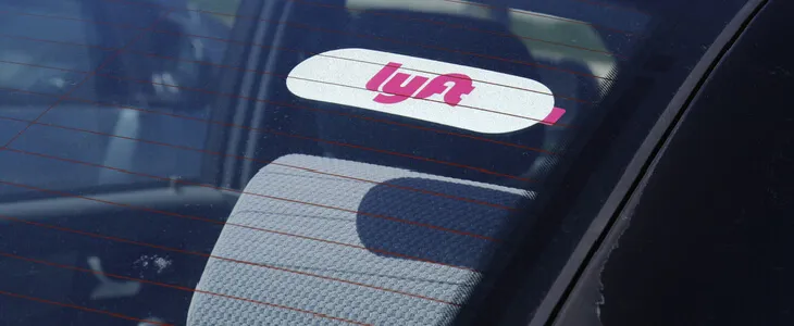 a car with a lyft sticker on its windshield