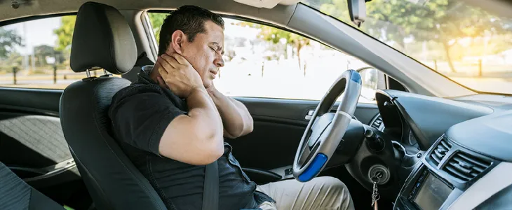 Man experiencing neck pain after a car accident